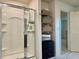 Modern bathroom with a glass shower, storage shelves, and a sleek design, offering a spa-like experience at 3836 Saddle Hill Way, Douglasville, GA 30135
