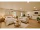 Cozy bedroom with seating area, including a bed and sofa with kitchen area in the background at 3836 Saddle Hill Way, Douglasville, GA 30135