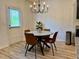 Charming dining area featuring a round table with stylish chairs and a modern chandelier, bathed in natural light at 3836 Saddle Hill Way, Douglasville, GA 30135