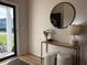 Stylish entryway featuring modern table, lamp, mirror and decorated with plants and vase at 3836 Saddle Hill Way, Douglasville, GA 30135