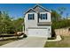 Charming two-story home featuring a gray exterior, a two-car garage, and a well-manicured front lawn at 3836 Saddle Hill Way, Douglasville, GA 30135