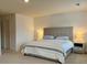 Spacious bedroom with a queen-size bed, neutral color palette, and carpeted floors at 3836 Saddle Hill Way, Douglasville, GA 30135