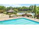 Community pool and sundeck with lounge chairs surrounded by lush landscaping at 3836 Saddle Hill Way, Douglasville, GA 30135