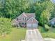 Aerial view of a brick home with a well-maintained lawn and landscape, complemented by mature trees at 4375 Split Creek Dr, Douglasville, GA 30135