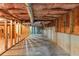 Unfinished basement with a concrete floor, exposed beams and wooden studs, with a staircase at 4375 Split Creek Dr, Douglasville, GA 30135