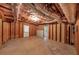 Unfinished basement with exposed beams, a door, and a window, perfect for future customization at 4375 Split Creek Dr, Douglasville, GA 30135