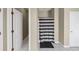 Hallway view of a bathroom featuring a shower with a striped curtain, white tile and neutral walls at 4375 Split Creek Dr, Douglasville, GA 30135
