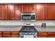 Close up of kitchen featuring granite countertops, stainless appliances, and wooden cabinets at 4375 Split Creek Dr, Douglasville, GA 30135