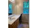 Bathroom vanity with a large mirror, lighting, and a window for natural light at 2858 Parkway Close, Lithonia, GA 30058