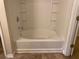 Bathroom featuring a soaking tub with tiled surround and integrated shelves at 2858 Parkway Close, Lithonia, GA 30058