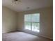 Bedroom with carpeted floor, overhead lighting, and a window overlooking the yard at 2858 Parkway Close, Lithonia, GA 30058