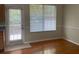 Bright dining room with hardwood floors, door to deck, and large window at 2858 Parkway Close, Lithonia, GA 30058