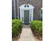 Inviting brick home entrance featuring a decorative doorway and well-maintained landscaping at 2858 Parkway Close, Lithonia, GA 30058