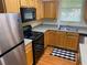 Well-lit kitchen featuring stainless steel appliances, wood cabinets, and a double sink at 2858 Parkway Close, Lithonia, GA 30058