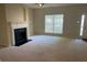 Bright living room with a fireplace, window and door enhancing natural light and access at 2858 Parkway Close, Lithonia, GA 30058