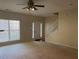 Comfortable living area featuring carpet, a ceiling fan, and a staircase at 2858 Parkway Close, Lithonia, GA 30058