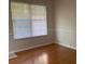 Inviting room featuring gleaming hardwood floors and a bright window at 2858 Parkway Close, Lithonia, GA 30058