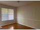 Room featuring hardwood floors, a window and neutral wall color, offering a versatile space at 2858 Parkway Close, Lithonia, GA 30058