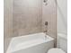 Bright bathroom with a white tub and tiled shower at 240 Walker Ave, Roswell, GA 30076