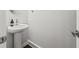 Stylish powder room features a pedestal sink and modern fixtures, offering convenience and elegance at 240 Walker Ave, Roswell, GA 30076