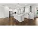 Bright kitchen with stainless steel appliances and island, open to dining and living area at 240 Walker Ave, Roswell, GA 30076
