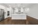 Bright kitchen with stainless steel appliances and island, open to dining and living area at 240 Walker Ave, Roswell, GA 30076