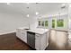Bright kitchen with stainless steel appliances and island, open to dining and living area at 240 Walker Ave, Roswell, GA 30076