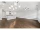 Spacious living room featuring hardwood floors and abundant natural light complements the sleek, white kitchen at 240 Walker Ave, Roswell, GA 30076