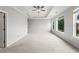 Spacious main bedroom with neutral tones, ceiling fan, and large windows for ample natural light at 240 Walker Ave, Roswell, GA 30076