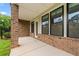 View of the covered patio, showing the brick column, door, and windows at 240 Walker Ave, Roswell, GA 30076
