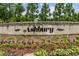 Ashbury brick sign surrounded by various flowers and greenery at 240 Walker Ave, Roswell, GA 30076