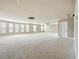 Large bonus room featuring neutral colored walls, carpet floors, and multiple windows at 3740 Lake Enclave Way, Atlanta, GA 30349