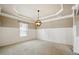 Elegant dining room features a tray ceiling, wainscoting, and soft neutral carpet at 3740 Lake Enclave Way, Atlanta, GA 30349