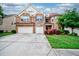 Beautiful two-story brick home with a two-car garage, landscaped front yard, and inviting entrance at 3740 Lake Enclave Way, Atlanta, GA 30349