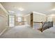 Second-floor hallway with decorative wrought iron railing and neutral carpeting at 3740 Lake Enclave Way, Atlanta, GA 30349
