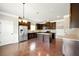 A modern kitchen features dark cabinetry, stainless steel appliances, and a functional center island at 3740 Lake Enclave Way, Atlanta, GA 30349