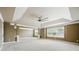 Large living area with a tray ceiling, ceiling fan, and multiple windows for natural light at 3740 Lake Enclave Way, Atlanta, GA 30349
