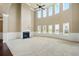 An expansive living room is filled with natural light and features a fireplace and soaring ceilings at 3740 Lake Enclave Way, Atlanta, GA 30349