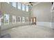 The spacious living room boasts soaring ceilings, abundant natural light, and elegant wainscoting at 3740 Lake Enclave Way, Atlanta, GA 30349