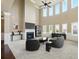 A living room featuring high ceilings, fireplace, windows, and carpeted floors at 3740 Lake Enclave Way, Atlanta, GA 30349
