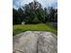 Spacious backyard with lush greenery, a wooden fence, a small shed, and a concrete patio at 3796 Melvin Sw Dr, Atlanta, GA 30331