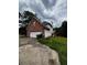 Back exterior of home showing garage, back deck, and some trees at 3796 Melvin Sw Dr, Atlanta, GA 30331