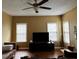A bright living room with hardwood floors, large windows, and a modern ceiling fan at 3796 Melvin Sw Dr, Atlanta, GA 30331