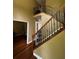 Staircase with wood railing and wrought iron spindles at 3796 Melvin Sw Dr, Atlanta, GA 30331