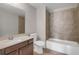 Modern bathroom featuring tile surround, vanity with sink, and bathtub and shower combination at 4204 Hardy Ave, Smyrna, GA 30082
