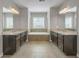 Luxurious primary bathroom with dual vanities, a soaking tub, and decorative lighting at 4204 Hardy Ave, Smyrna, GA 30082