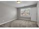 A bright, carpeted bedroom with a large window offers great natural light and a peaceful atmosphere at 4204 Hardy Ave, Smyrna, GA 30082