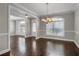 Elegant dining room featuring hardwood floors, chandelier, and large windows at 4204 Hardy Ave, Smyrna, GA 30082