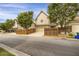 Exterior shot showcasing home facade, driveway, with wooden fence and street view, enhancing curb appeal at 4204 Hardy Ave, Smyrna, GA 30082