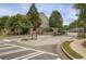 Welcoming gated community entrance with stone pillars and mature trees at 4204 Hardy Ave, Smyrna, GA 30082